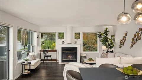 a living room with furniture a fireplace and a large window