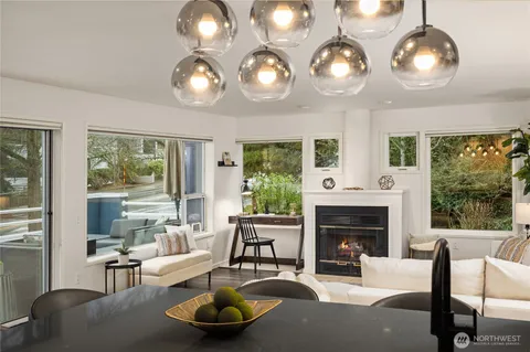 a living room with furniture a large window and a fireplace