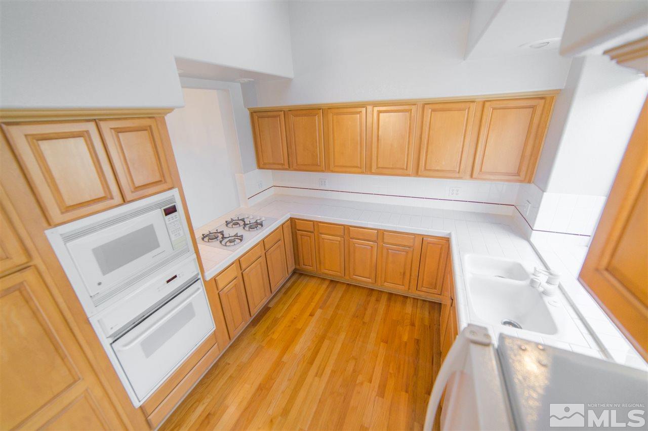 2493 Granite Springs Road Reno, NV 89519 - Photo 5 of 13 a view of walk in closet with wooden floor