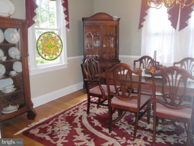 111 South Rolling Road Catonsville, MD 21228 - Photo 7 of 25 a view of a dining room with furniture and wooden floor