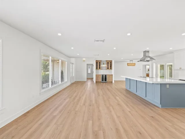 a large kitchen with kitchen island a sink and a stove top oven
