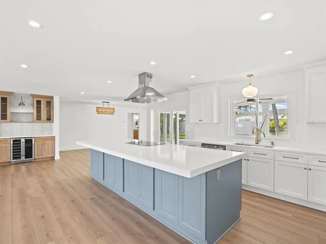 a kitchen with cabinets appliances and a window