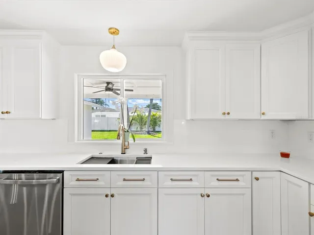 a view of kitchen with granite countertop cabinets and outdoor space