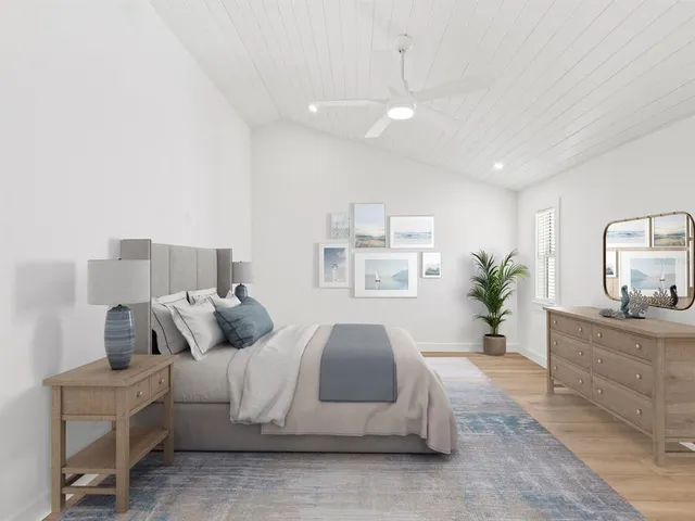 an empty room with wooden floor cabinet and windows