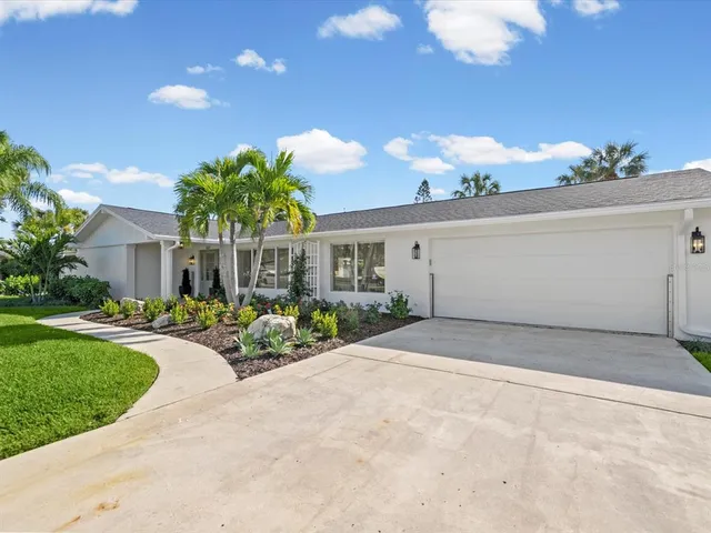 a front view of a house with a yard and fountain