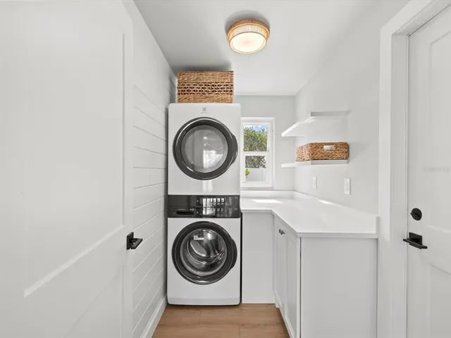 a view of a house with a big yard and large tree