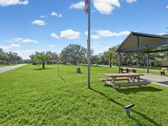 an aerial view of a house an outdoor space and seating area