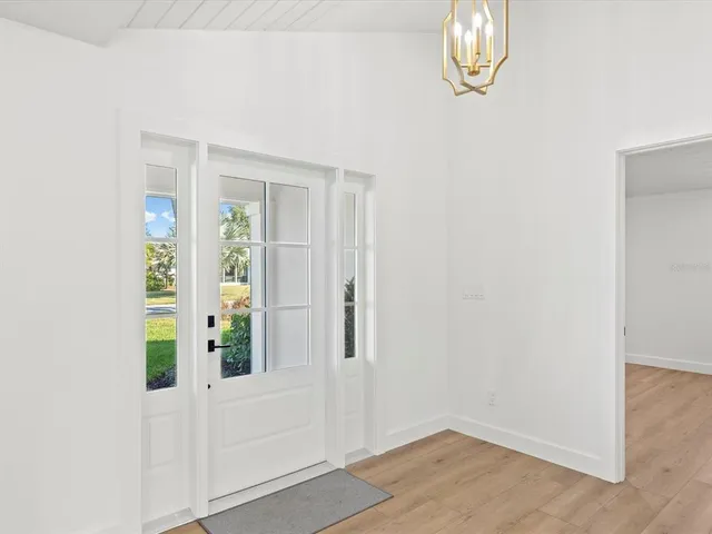 a living room with furniture wooden floor and a table