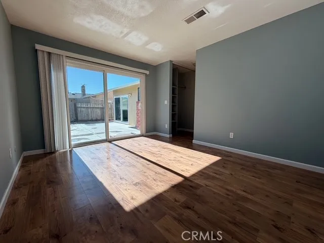 a view of hallway with wooden floor and sliding door