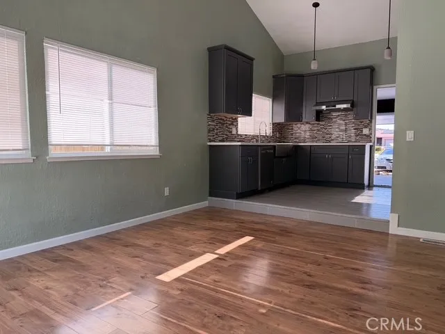 a kitchen with stainless steel appliances granite countertop a sink stove refrigerator and cabinets