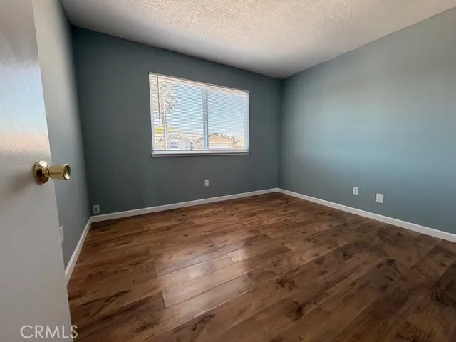 a view of a room with wooden floor and windows