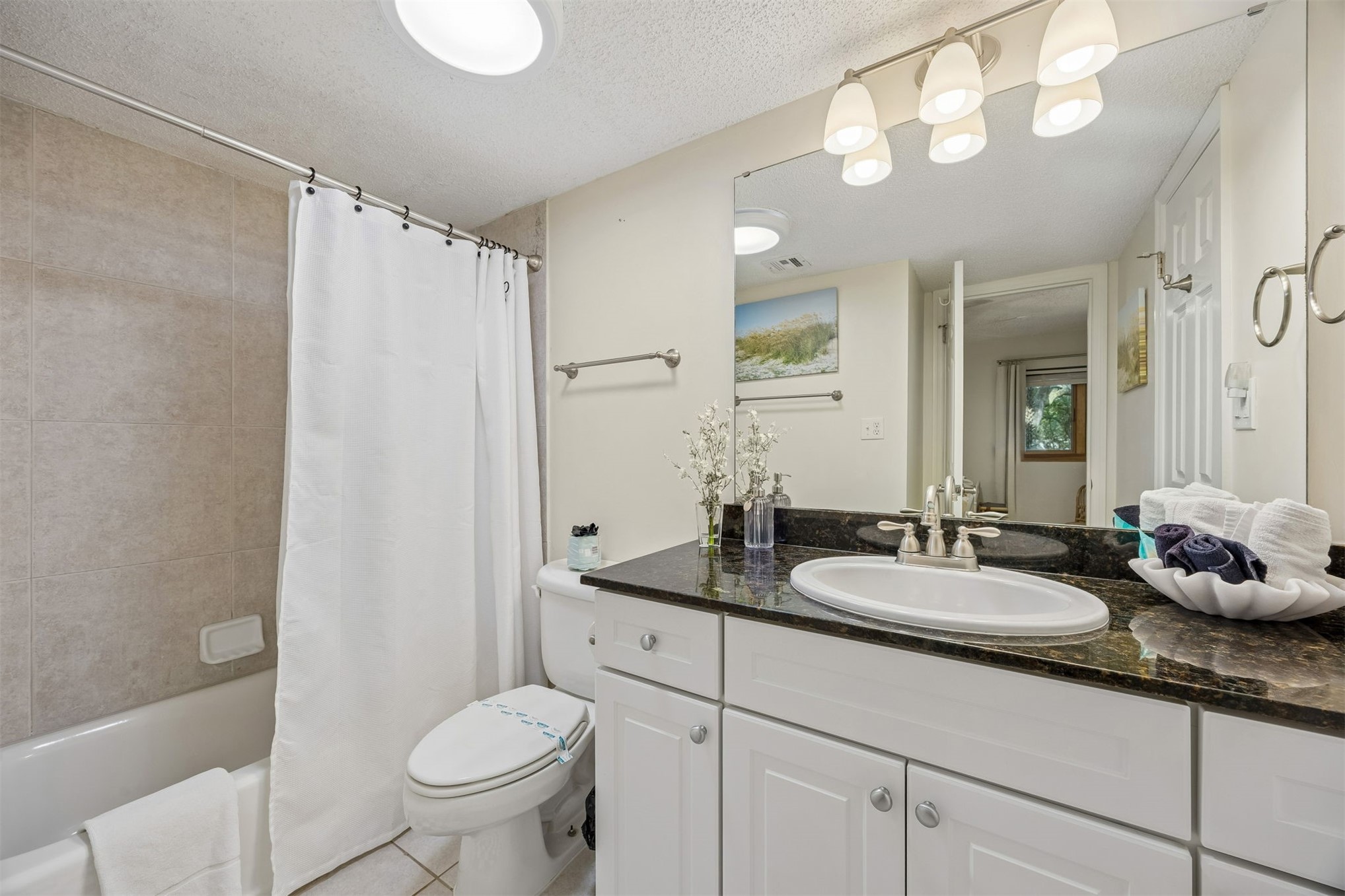2014 Beachwood Road, Unit 2014 Amelia Island, FL 32034 - Photo 19 of 36 a bathroom with a granite countertop sink mirror vanity and toilet