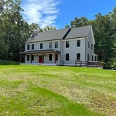 a front view of house with yard and green space