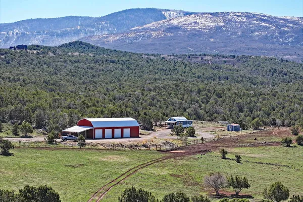 a view of a house with a yard and a mountain