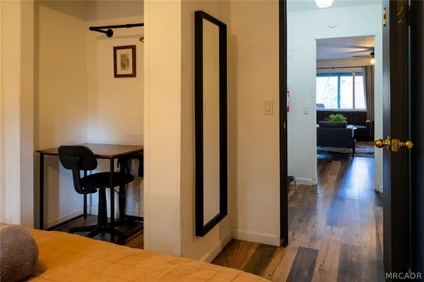 a bedroom with a bed and wooden floor