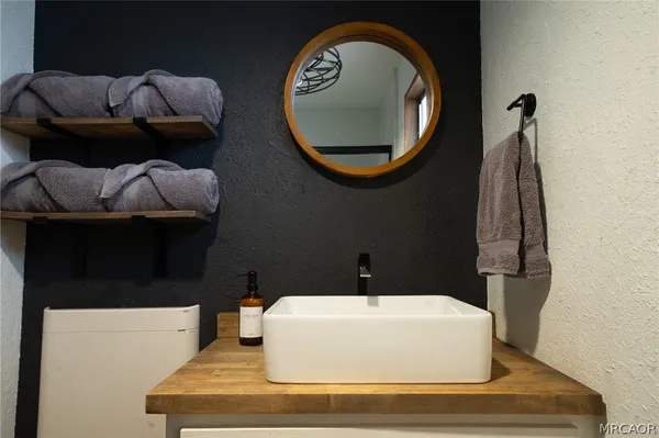 a bathroom with a sink and a mirror