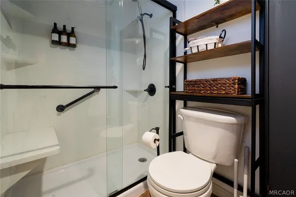 a white toilet sitting next to a bathroom sink