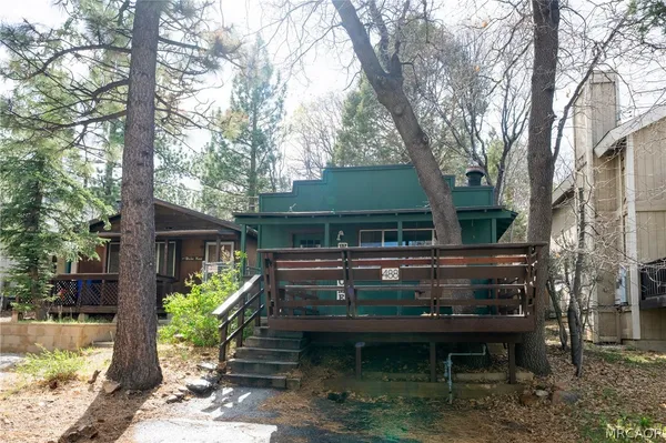 a view of house with backyard and a garden