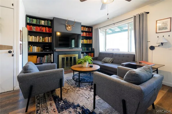 a living room with furniture a rug and a flat screen tv