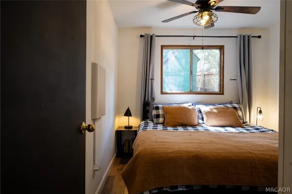 a bedroom with a bed and a chandelier