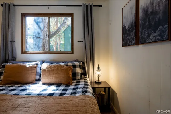 a bedroom with a bed and a window with outer view
