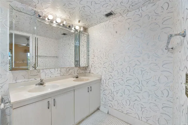 a bathroom with a sink vanity granite and a mirror