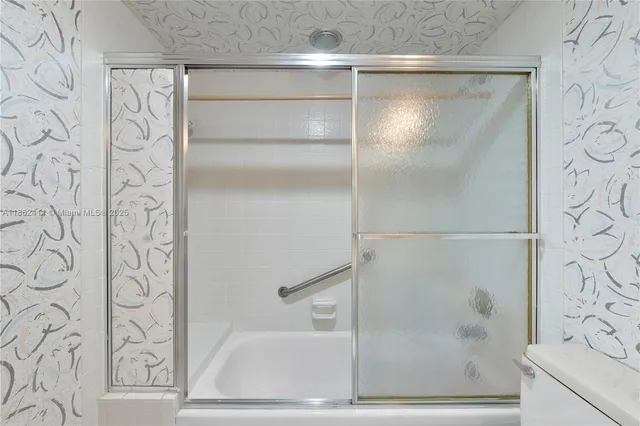 a bathroom with a bathtub and shower