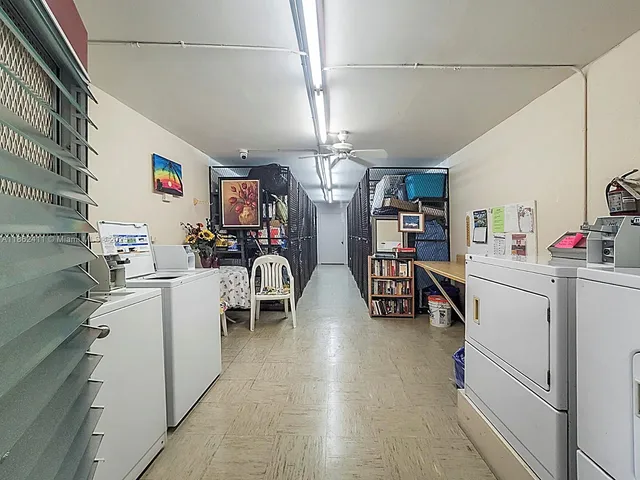 a kitchen with refrigerator and cabinets