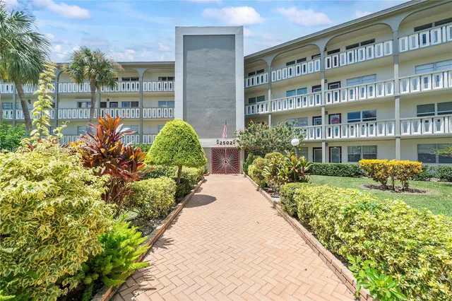 a view of swimming pool with outdoor seating and plants