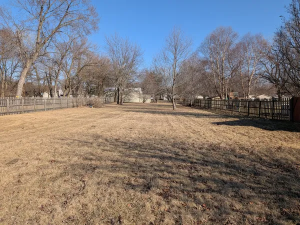 a view of yard covered with snow in back yard