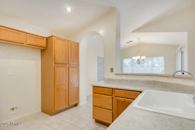 a room with wooden cabinets and glass door