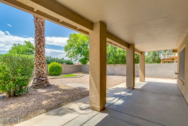 a view of porch with a floor to ceiling window and potted plants