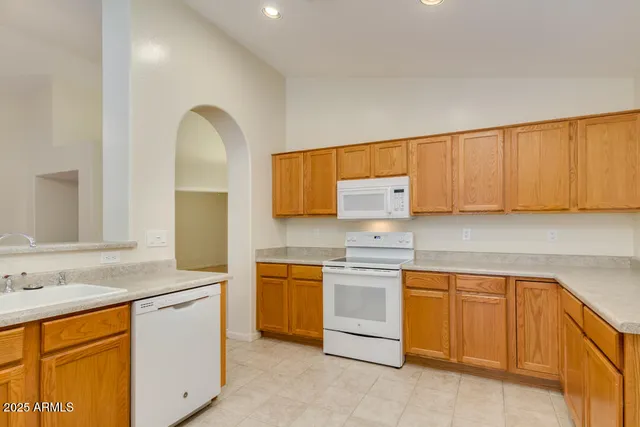 a kitchen with cabinets appliances and a counter space