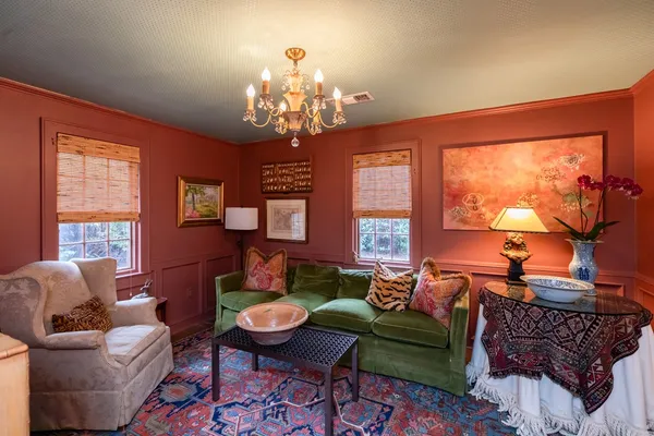 a living room with furniture and a chandelier