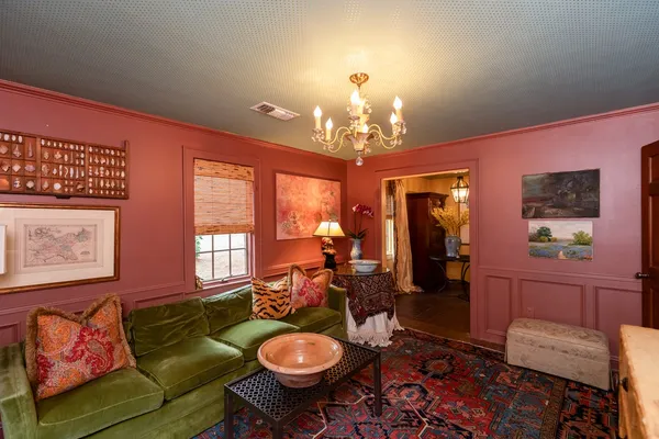 a living room with furniture and a chandelier
