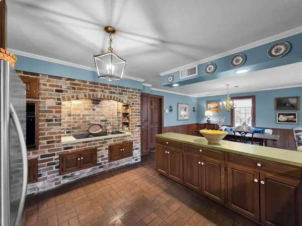 a large kitchen with stainless steel appliances granite countertop a stove and a sink