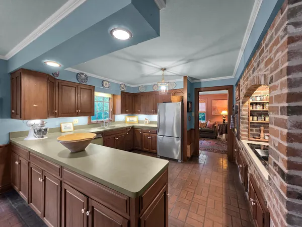 a kitchen with a refrigerator a sink and wooden cabinets