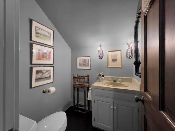 a bathroom with a toilet sink and mirror