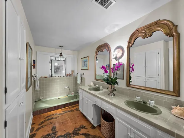 a bathroom with a granite countertop sink a mirror and a shower
