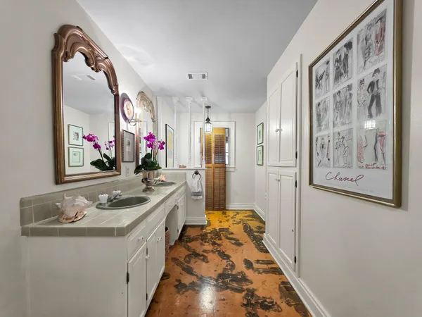 a bathroom with a sink vanity and a mirror