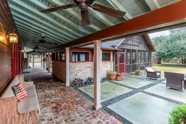 a view of a porch with furniture and a yard