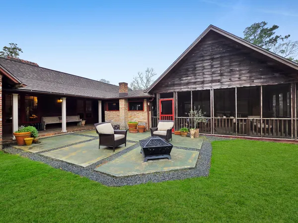 a view of a house with furniture and garden