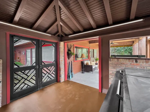 a view of a hallway with a bike and wooden roof