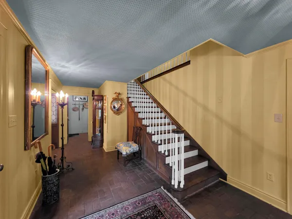 a view of a livingroom with furniture and staircase