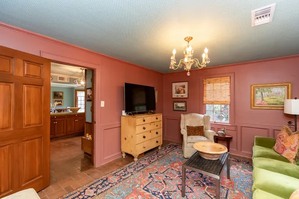 a spacious bedroom with furniture and a flat screen tv