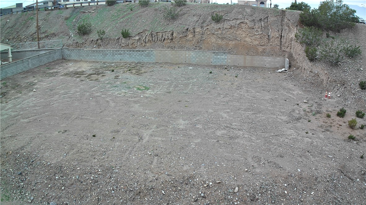 1551 Turquoise Road Bullhead City, AZ 86442 - Photo 1 of 9 a view of a dry yard with wooden fence