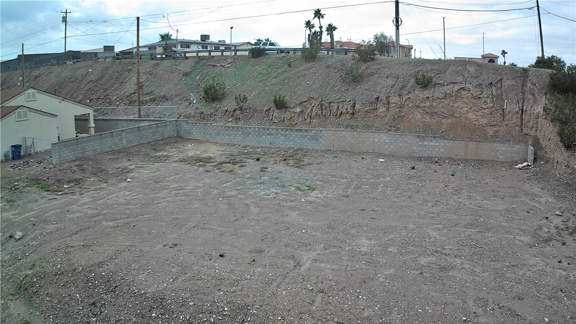 1551 Turquoise Road Bullhead City, AZ 86442 - Photo 5 of 9 a view of a dry yard with wooden fence