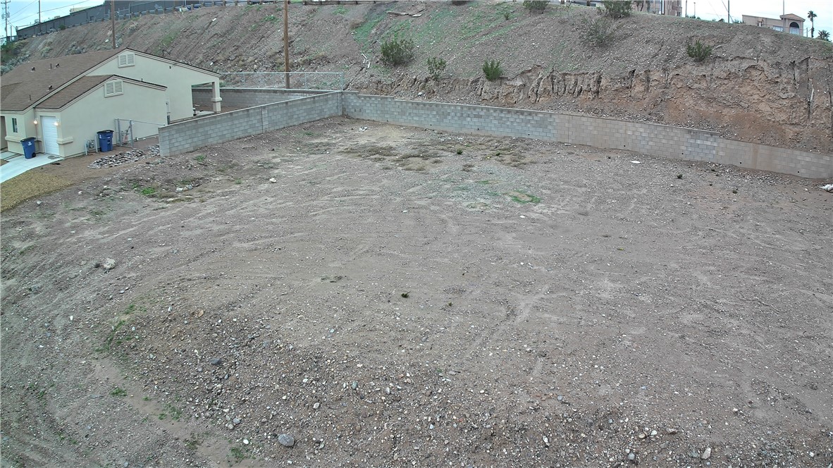 1551 Turquoise Road Bullhead City, AZ 86442 - Photo 6 of 9 a view of a dry yard with wooden fence