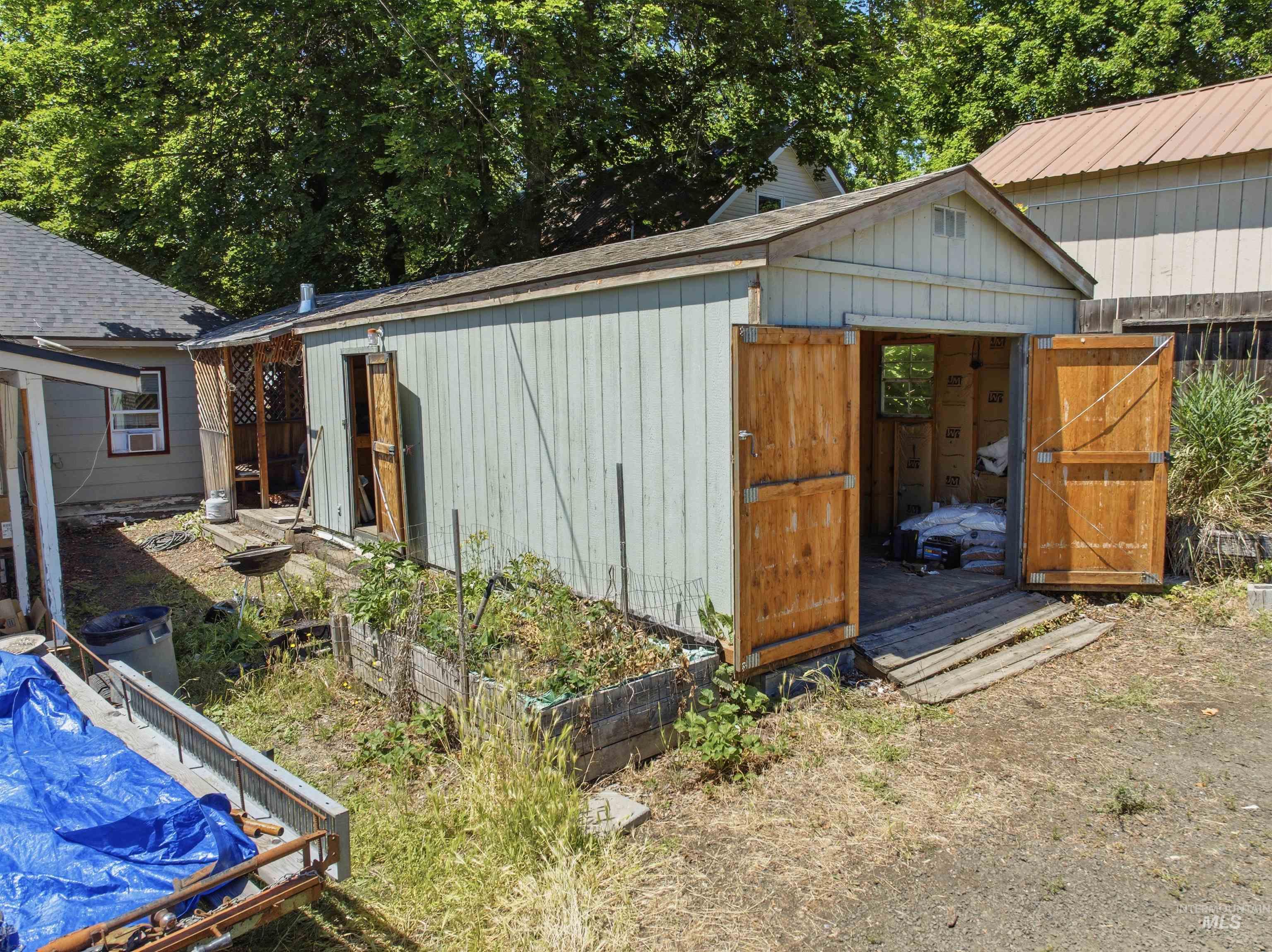 735 Oak Street Potlatch, ID 83855 - Photo 15 of 30 Detached shed with double wooden doors and a pitched roof