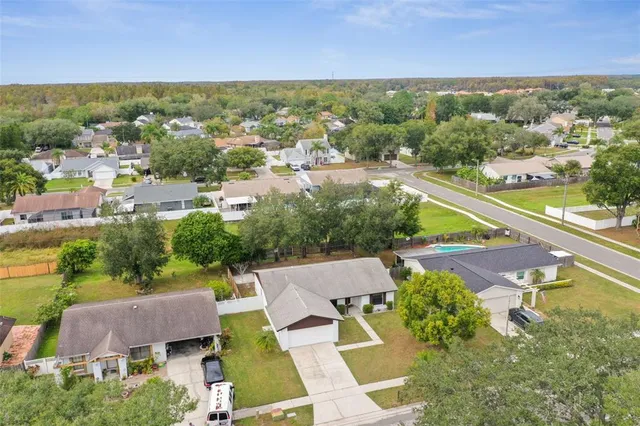 an aerial view of residential houses with outdoor space and swimming pool